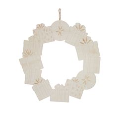 an ornament shaped like a wreath with gift boxes on it