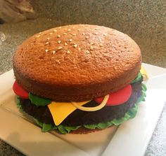 a large hamburger sitting on top of a white plate