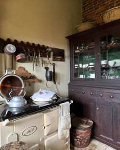 an old fashioned stove with pots and pans on it