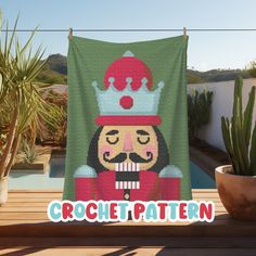 a blanket with a cartoon character on it next to a potted cacti