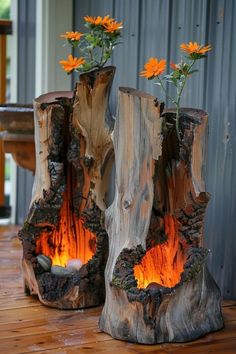 two vases made out of logs with flowers in them