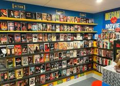 there are many movies on the shelves in this movie store that is full of them