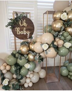 a bunch of balloons that are in front of a sign with the words oh baby on it