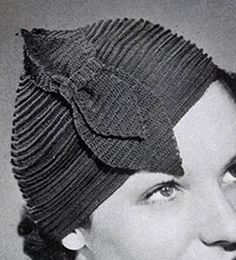 black and white photograph of a woman wearing a knitted hat with a flower on it