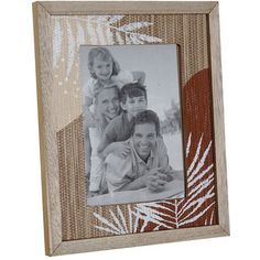 an image of two people and a child in a frame with palm leaves on it