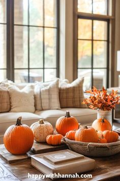 a living room filled with lots of pumpkins on top of a wooden coffee table