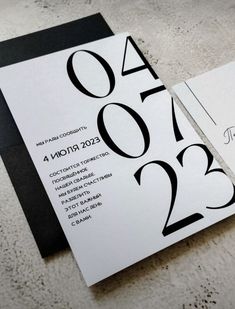 two black and white wedding cards with the numbers twenty four on them, sitting next to each other