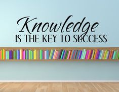 a wall decal that reads,'knowledge is the key to success'in front of a bookshelf