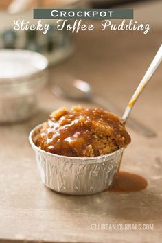 a close up of a muffin in a tin with caramel sauce on it