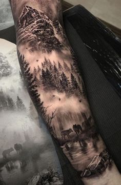 a man's arm with an image of trees and animals in the woods on it