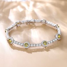 Our "Noble Allure" tennis bracelet is a masterpiece of elegance and sophistication, designed to captivate and enchant. The halo setting magnifies its beauty and brilliance. This bracelet is a mix of classic style and modern flair, perfect for anyone looking to add a touch of luxury to their look. Material: 925 Sterling Silver Length: 18cm Bracelet width: 8mm Gemstone width: 5mm Luxury Elegant Peridot Jewelry, Halo Setting, August Birthstone, Bracelet Online, August Birth Stone, Sterling Silver Bracelet, Tennis Bracelet, Sterling Silver Bracelets, Birthstone