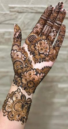 the hand is decorated with henna on it and has intricate designs, like this one