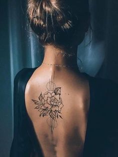 a woman with a flower tattoo on her back