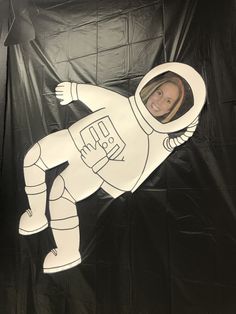 a cardboard cut out of an astronaut floating in space