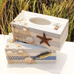 two boxes with seashells and starfish on them