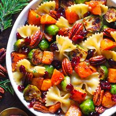 a white bowl filled with pasta and veggies