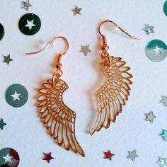 Delicate and under stated, these gold pegasus wing drop earrings are both durable and light as a feather! Hand etched in gold, the design features a feathered wing pattern.  As each pair is hand made no one is quite the same making them unique. Finished with gold plated ear wires and rubber earring backs. All my earrings are nickel free and hypoallergenic. Presented in a stylish, recycled, navy blue, cardboard gift box. All orders are shipped with Royal Mail standard 1st class. Gold Feather Earrings As A Gift, Gold Feather Earrings For Gift, Wing Pattern, Gold Wing, Cardboard Gift Boxes, Vintage Baby Clothes, Bridesmaid Gift Boxes, Travel Jewelry Box, Mixed Metal Jewelry