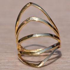 The School Lane: Yellow Gold Cocktail Statement Ring. The Ring Features Five Rows Of Polished Gold In A Chevron Shape To Straight In A Pattern To Create A Large Fan Across The Top Of The Finger. The Ring Is Crafted In Yellow Gold And Is Currently A Finger Size 6.25 Yet Can Be Adjusted To Any Finger Size For An Additional Charge On Request. Adjustable Gold Fusion Rings, Gold Fusion Style Ring Jewelry, Formal Fusion Rings With Polished Finish, Gold Rings With Polished Finish Fusion Style, Fusion Style Yellow Gold Open Ring Jewelry, Yellow Gold Polished Fusion Rings, Fusion Style Polished Yellow Gold Rings, Yellow Gold Fusion Rings With Polished Finish, Formal Gold Jewelry With Open Band