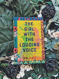 the girl with the louding voice by abi dare is surrounded by leaves and flowers