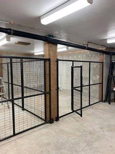 the inside of a building with metal bars and doors on each side, in front of an unfinished wall