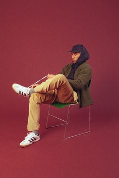 a man sitting on top of a green chair