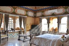 an ornate bedroom with white bedding and windows