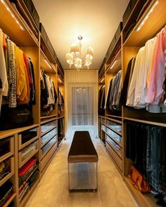 a walk in closet filled with lots of clothes