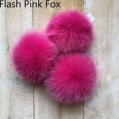 pink fox fur pom - poms on wooden background with text that reads flash pink fox