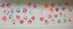 colorful paper fish are hanging on the wall