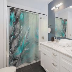 a bathroom with blue and white shower curtain in it's center, next to a toilet