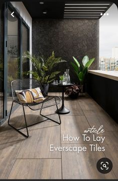 a balcony with a chair, table and potted plants on the floor next to it