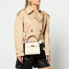 Tory Burch's petite Lee Radziwill double bag combines suede and leather in mixed media, resulting in a sleek yet versatile silhouette. With layers that unfurl like a trench coat collar, it can be worn open, partially buttoned or fully closed..Tory Burch Lee Radziwill bag.Cream leather and suede.Top handle, adjustable shoulder strap, gold-tone hardware, debossed logo.Four internal compartments, two internal card slots, fully lined.Designer colour: New Cream.Snap closure.Dimensions: H: 16cm x W: 19cm x D: 9cm Luxury Beige Satchel For Fall, Cream Leather Bag For Fall, Designer Beige Satchel For Workwear, Designer Beige Satchel For Work, Designer Beige Bags For Fall, Beige Leather Satchel For Fall, Luxury Beige Bags For Fall, Tory Burch Lee Radziwill Bag Outfit, Tory Burch Lee Radziwill Double Bag