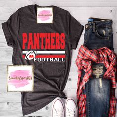 a shirt, jeans and sneakers are laid out on a wooden floor with the words panther's football printed on it