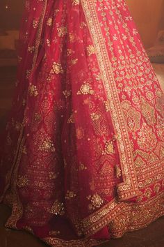 Rani attached cancan lehenga with zardozi, thread, sequin embroidery in floral pattern. Paired with sweetheart neck padded blouse and embroidered dupatta.
Components: 3
Pattern: Embroidery
Type Of Work: Zardozi, cutdana, sequin, thread
Neckline: Sweetheart neck
Sleeve Type: Half sleeves
Fabric: Raw Silk
Color: Pink
Other Details: 
Lehenga:
Attached cancan
Floral pattern
Length: Approx 43 - 44 inches
Blouse:
Padded
Dupatta:
Embroidered borders
Semi sheer
Occasion: Bride - Aza Fashions Floor-length Tilla Gown For Wedding, Traditional Tilla Gown For Ceremonies, Traditional Kundan Lehenga With Tilla Details, Floor-length Lehenga With Dupatta For Traditional Ceremonies, Anarkali Set With Tilla For Traditional Ceremonies, Anarkali Wedding Gown With Tilla Embroidery, Festive Anarkali Set With Tilla For Traditional Ceremonies, Semi-stitched Gown With Dori Work For Traditional Ceremonies, Anarkali Wedding Gown With Tilla Details