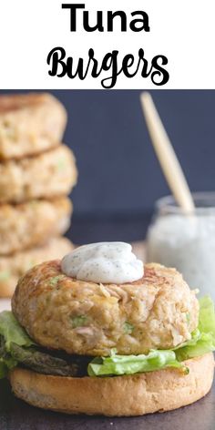 there is a burger with lettuce and cheese on it next to some cookies