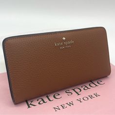 Brand New With Tag Kate Spade Dumpling Pebbled Leather Large Slim Bifold Wallet Product Details Color: Warm Gingerbread 3.5" H 6.7" W Pebbled Leather Ksny Metal Pinmount Logo Two Way Spade Jaquard Lining Interior: 12 Credit Card Slots Id Window 4 Slip Pockets Exterior: Zip Pocket On Back Snap Closure Dust Bag Not Included Imported Kate Spade Brown Rectangular Wallets, Kate Spade Brown Everyday Wallet, Kate Spade Leather Wallet With Card Slots, Kate Spade Leather Wallets With Card Slots, Kate Spade Leather Wallets For Everyday Use, Kate Spade Everyday Bifold Bag, Formal Kate Spade Leather Wallets, Kate Spade Leather Wallet With Zipper Closure, Luxury Leather Wallet By Kate Spade