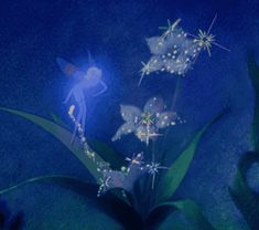 a flower with white flowers on it and a fairy sitting next to it in the dark