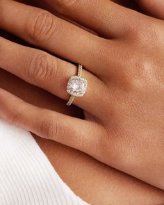 a woman's hand with a diamond ring on it