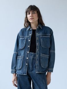 a woman wearing an oversize denim jacket