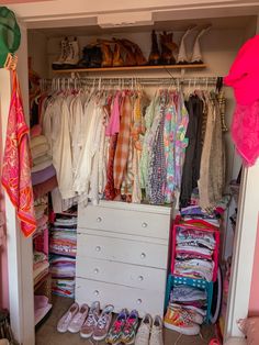 a closet filled with lots of clothes and shoes