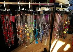 many necklaces are hanging on a rack