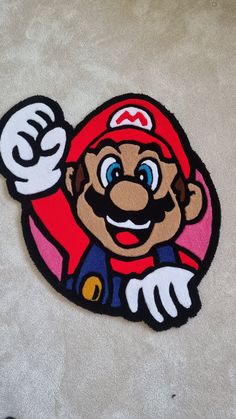 an image of a mario mouse rug on the floor with it's hand up