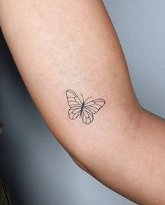 a small butterfly tattoo on the right arm and shoulder, it appears to be in black ink