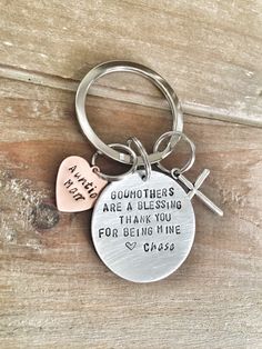 a keychain with two hearts attached to it that says, godmoters are blessing