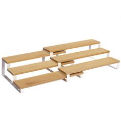 three wooden benches sitting next to each other on top of a white floor and one bench is made out of wood