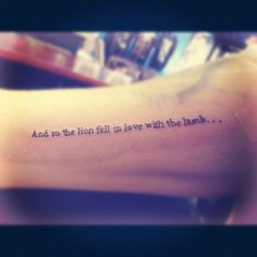 a person with a tattoo on their arm that says and so the hell fell in love with the lamb