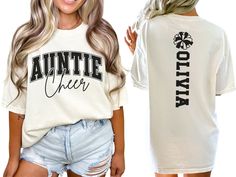 Show your spirit on game day with our custom Cheerleader Aunt shirt, featuring a varsity style "cheer auntie" design personalized with the cheerleaders name on back. This cute and stylish shirt makes the perfect gift for any cheer auntie passionate about cheerleading. COMFORT COLORS 1717 SHIRT: Unisex 100% US cotton - ethically grown and harvested Pre-Shrunk Fabric Relaxed Fit - Size up for a trendy oversized look Seamless Sides Double Needle Stitching Garment-dyed  CARE INSTRUCTIONS: Wash insid Customizable Casual T-shirt For Cheerleading, Varsity T-shirt With Custom Print For Game Day, Cheer Aunt Shirt Ideas, Customizable Short Sleeve Tops For Cheerleading, School Spirit Tops With Custom Print For Game Day, Collegiate T-shirt For Cheerleading With Team Name, Customizable Varsity Short Sleeve Tops, School Spirit Tops With Custom Print For Fan Gear, Custom Print School Spirit Tops For Fan Gear