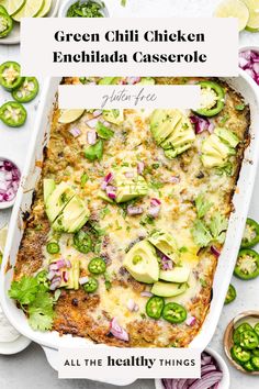 an enchilada casserole in a white dish with sliced jalapenos on the side