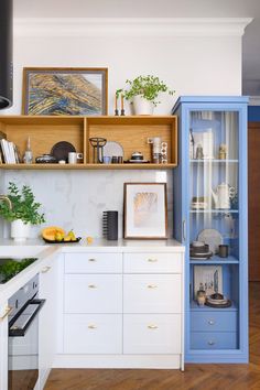 the kitchen is clean and ready for us to use it's blue cabinet doors