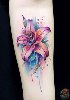 a colorful flower tattoo on the leg with watercolor paint splashs and dots around it